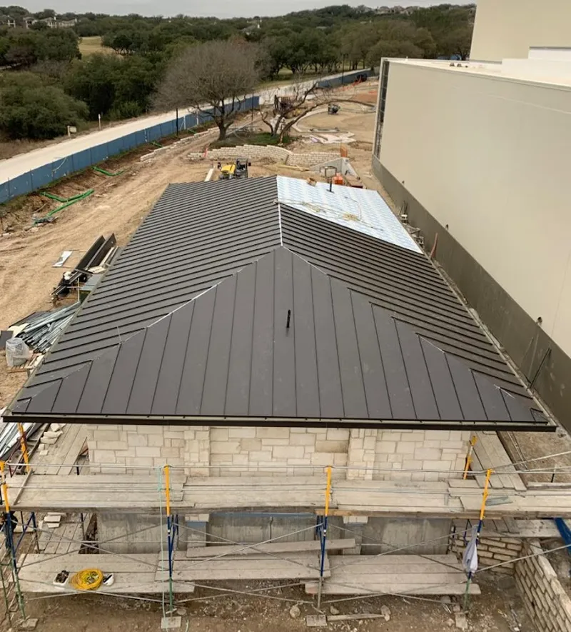 Metal roof new construction with scaffolding in Forsyth